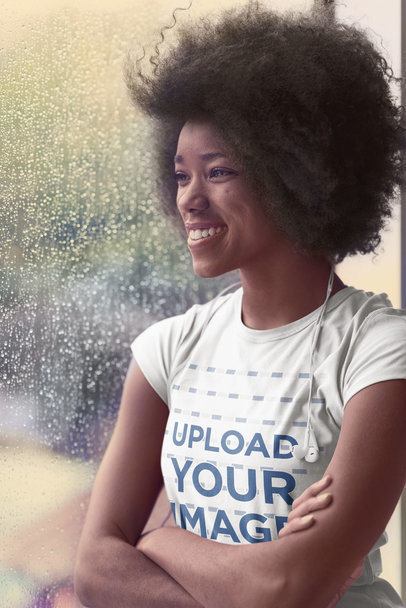 T-Shirt Mockup Featuring a Woman on a Rainy Day