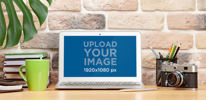 Mockup of a MacBook Air Placed on a Desk by a Vintage Camera