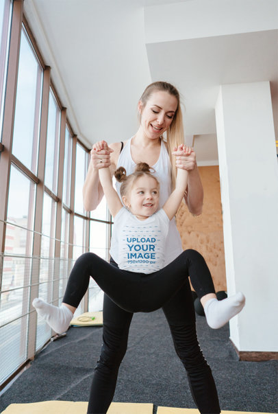 T-Shirt Mockup Featuring a Little Girl Being Lifted by Her Mom