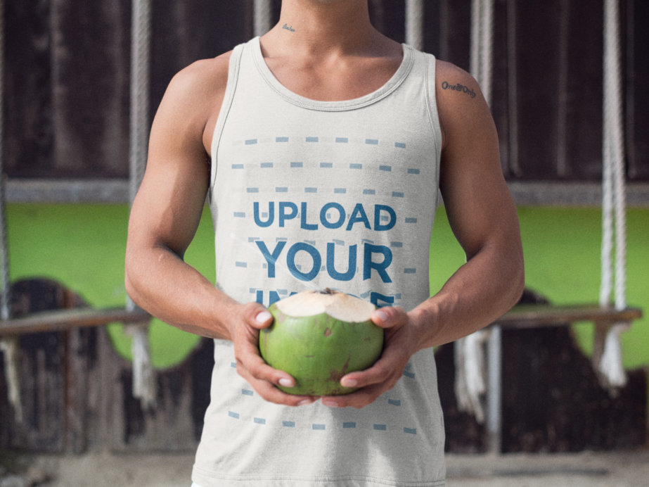 Tank Top Mockup of a Guy at the Beach Drinking a Coconut
