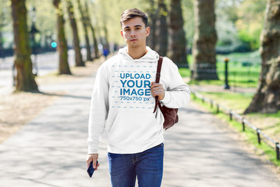 Pullover Hoodie Mockup of a Man Walking Through a Park