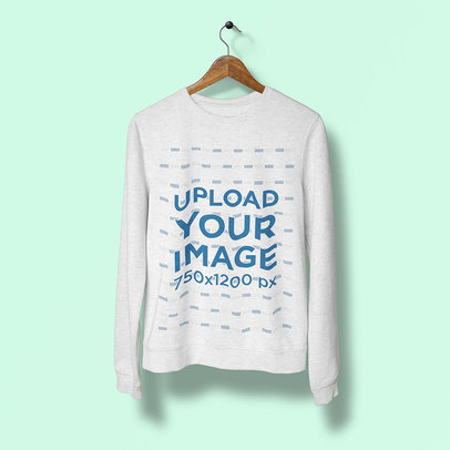 Mockup of a Heather Sweatshirt on a Wooden Hanger