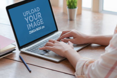 Mockup of a Woman Working on a MacBook Pro at Home