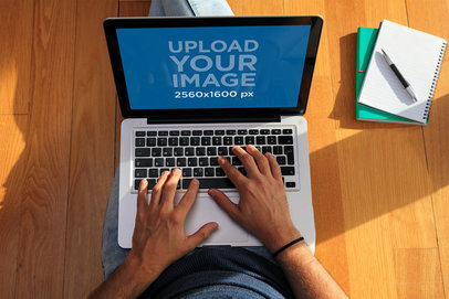 MacBook Pro Mockup of a Man Sitting on the Floor 36701-r-el2
