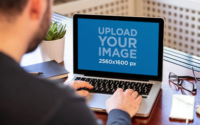 MacBook Mockup of a Man Working from Home