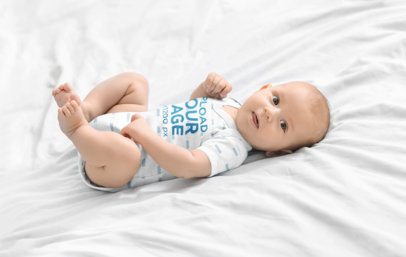 Onesie Mockup Featuring a Baby Boy Lying in Bed