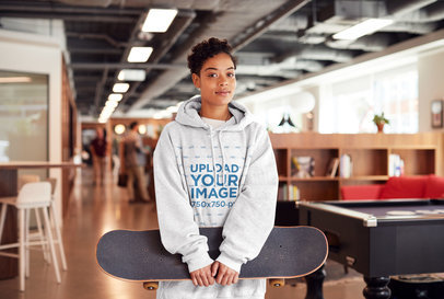 Heather Pullover Hoodie Mockup of a Woman Holding a Skateboard