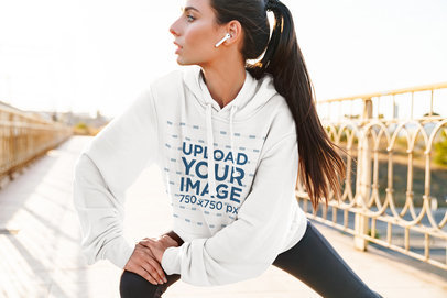 Mockup of a Woman with an Oversized Hoodie Stretching on the Street