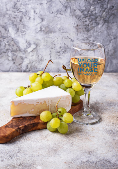 Mockup of a Wine Glass Next to a Piece of Cheese