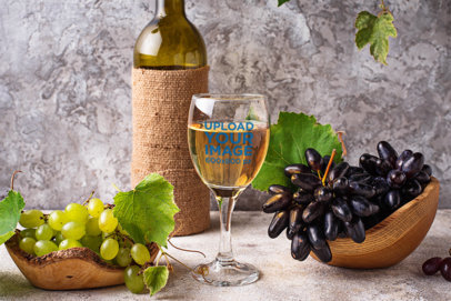 Wine Glass Mockup Featuring Grapes and a Wine Bottle 