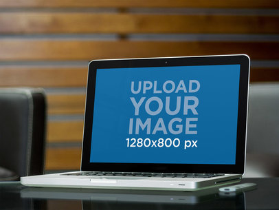Mockup of a MacBook Placed on a Glass Table 