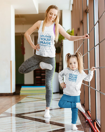 Tank Top Mockup of a Mom and Her Daughter with a Hoodie Practicing Ballet 