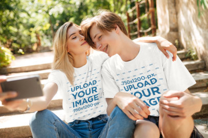 T-Shirt Mockup Featuring a Young Couple Taking a Selfie