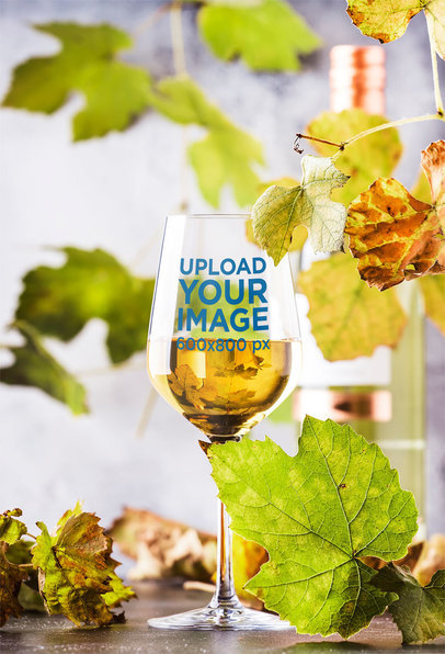 Mockup of a Wine Glass Surrounded by Green Leaves 36710-r-el2