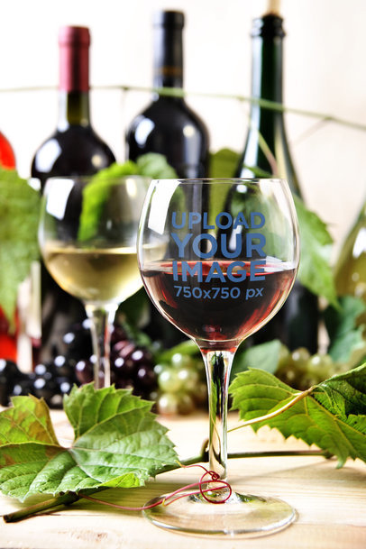 Wine Glass Mockup Featuring Some Bottles 