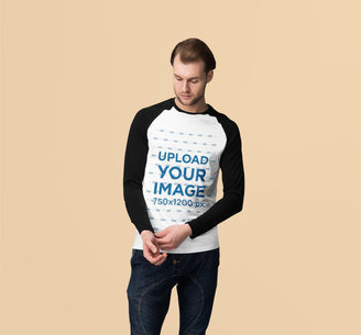 Mockup of a Serious Man Wearing a Raglan Long Sleeve Tee at a Studio 