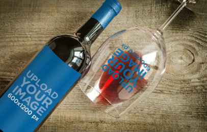 Mockup of a Wine Bottle and a Glass Lying over a Wooden Surface