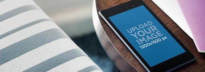 Mockup Featuring a Nexus 7 Placed on a Round Wooden Table