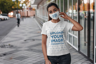 Mockup of a Young Woman Wearing a T-Shirt and a Face Mask on the Street 4554-el1