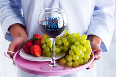Mockup of a Sommelier Carrying a Tray with a Wine Glass and Berries