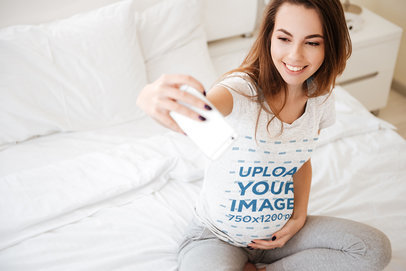 Heathered T-Shirt Mockup of a Pregnant Woman Taking a Selfie