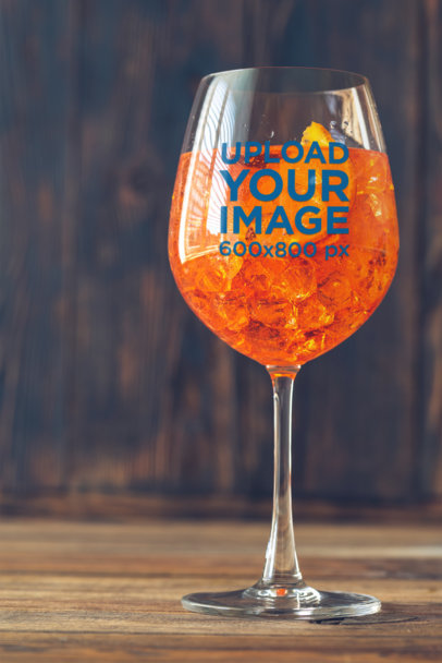 Mockup of a Wine Glass with an Orange-Infused Drink