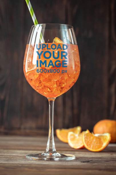 Mockup of a Wine Glass Filled with a Cold Orange Drink
