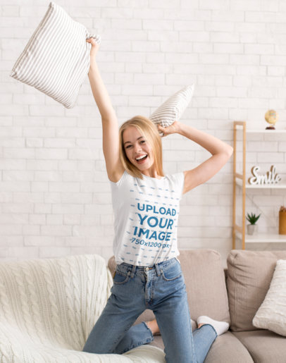 T-Shirt Mockup Featuring a Happy Woman Playing on a Couch 