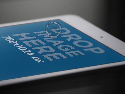 White iPad Mini Mockup in Angled Closeup View Over a Black Surface a12761