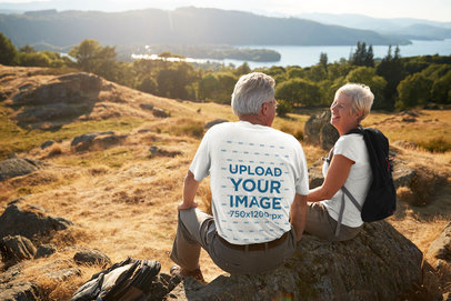 Back View T-Shirt Mockup Featuring an Elderly Couple Hiking 