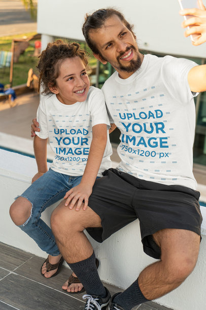T-Shirt Mockup of a Man Taking a Selfie with His Kid