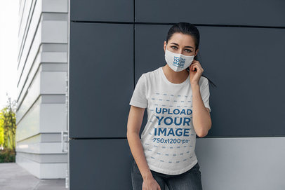 Mockup of a Woman Wearing a Customizable Face Mask and a T-Shirt 