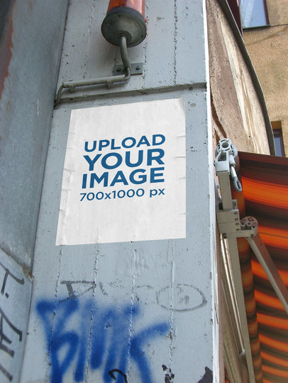 Mockup of a Poster Glued to a Wall with Graffiti