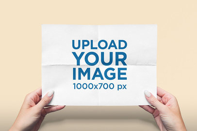 Mockup Featuring Two Hands Holding a Horizontal Flyer Against a Solid Color Backdrop