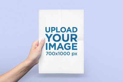 Mockup Featuring a Woman's Hand Holding a Vertical Flyer 
