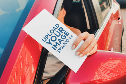 Mockup of a Woman Holding a Flyer in Her Car Window