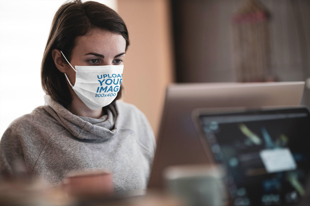 Mockup of a Woman Wearing a Face Mask While Working