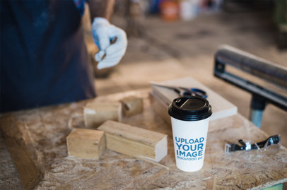 Mockup of a Coffee Cup on a Work Table 36521-r-el2