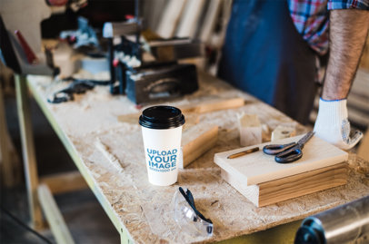 Coffee Cup Mockup of a Man in a Woodworking Workshop 36519-r-el2