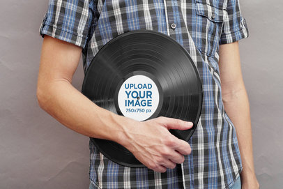 Mockup of a Man Holding a Vinyl Record