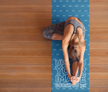 Top-View Mockup of a Woman Stretching on a Yoga Mat