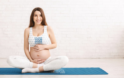 Sports Bra Mockup Featuring a Pregnant Woman Sitting on a Customizable Yoga Mat 