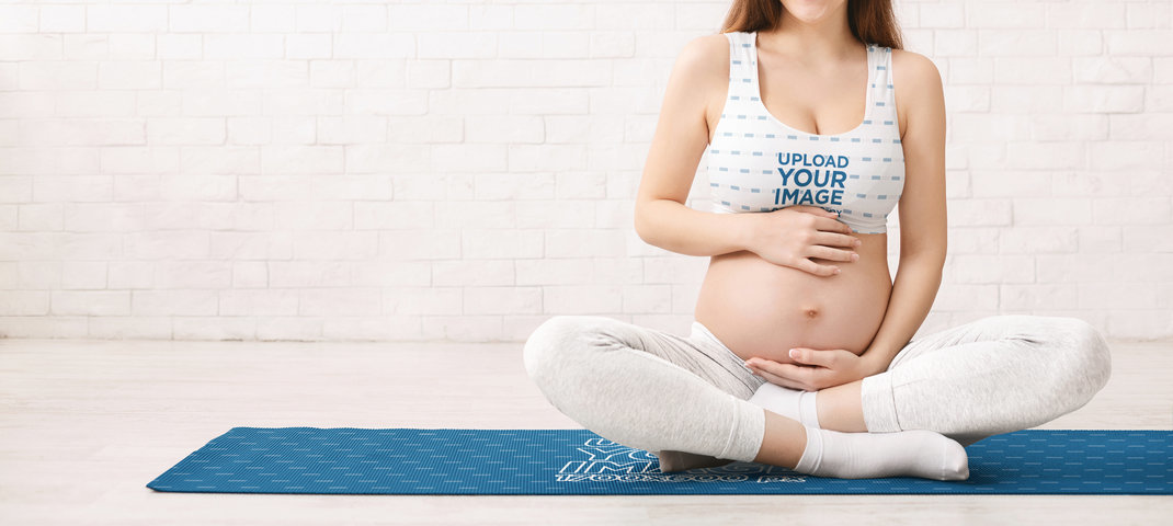 Sublimate Sports Bra Mockup of a Pregnant Woman Sitting on a Yoga Mat 