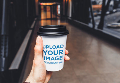 Mockup of a Man Holding an Eco-Friendly Paper Cup 36524-r-el2