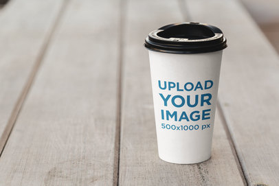 Mockup of a Coffee Cup Placed on a Wooden Bench