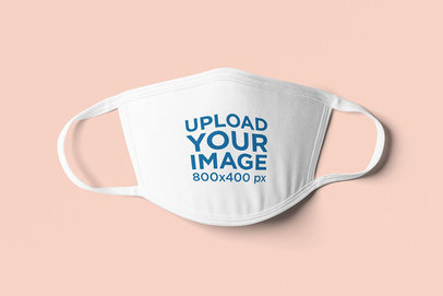Mockup Featuring a Face Mask Lying on a Plain Color Surface 