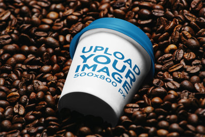 Mockup of a Paper Cup Placed over a Bunch of Coffee Beans