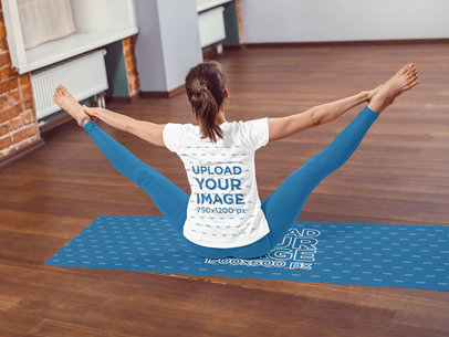 Back View T-Shirt Mockup of a Woman Stretching Her Legs on a Yoga Mat 