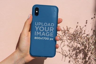 Mockup of a Woman Holding a Clear Phone Case Under the Sunlight