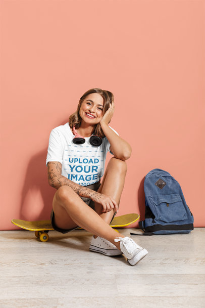 T-Shirt Mockup Featuring a Woman with Headphones Sitting on a Skateboard 